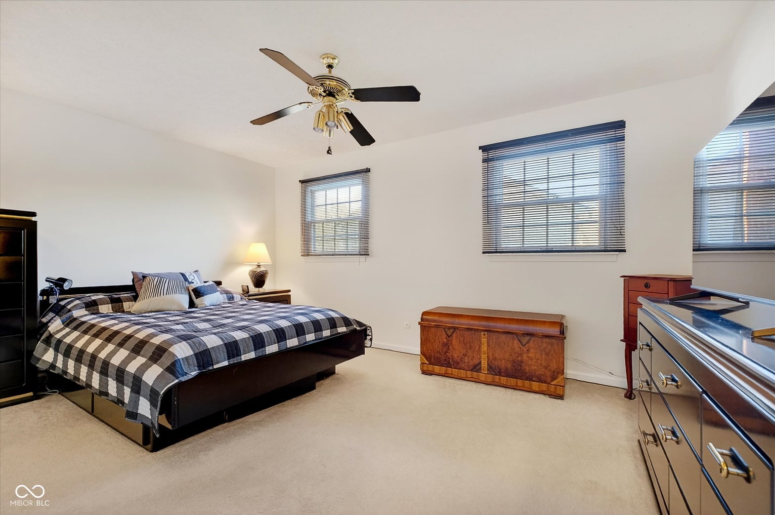 Spacious primary bedroom with abundant natural light and windows.