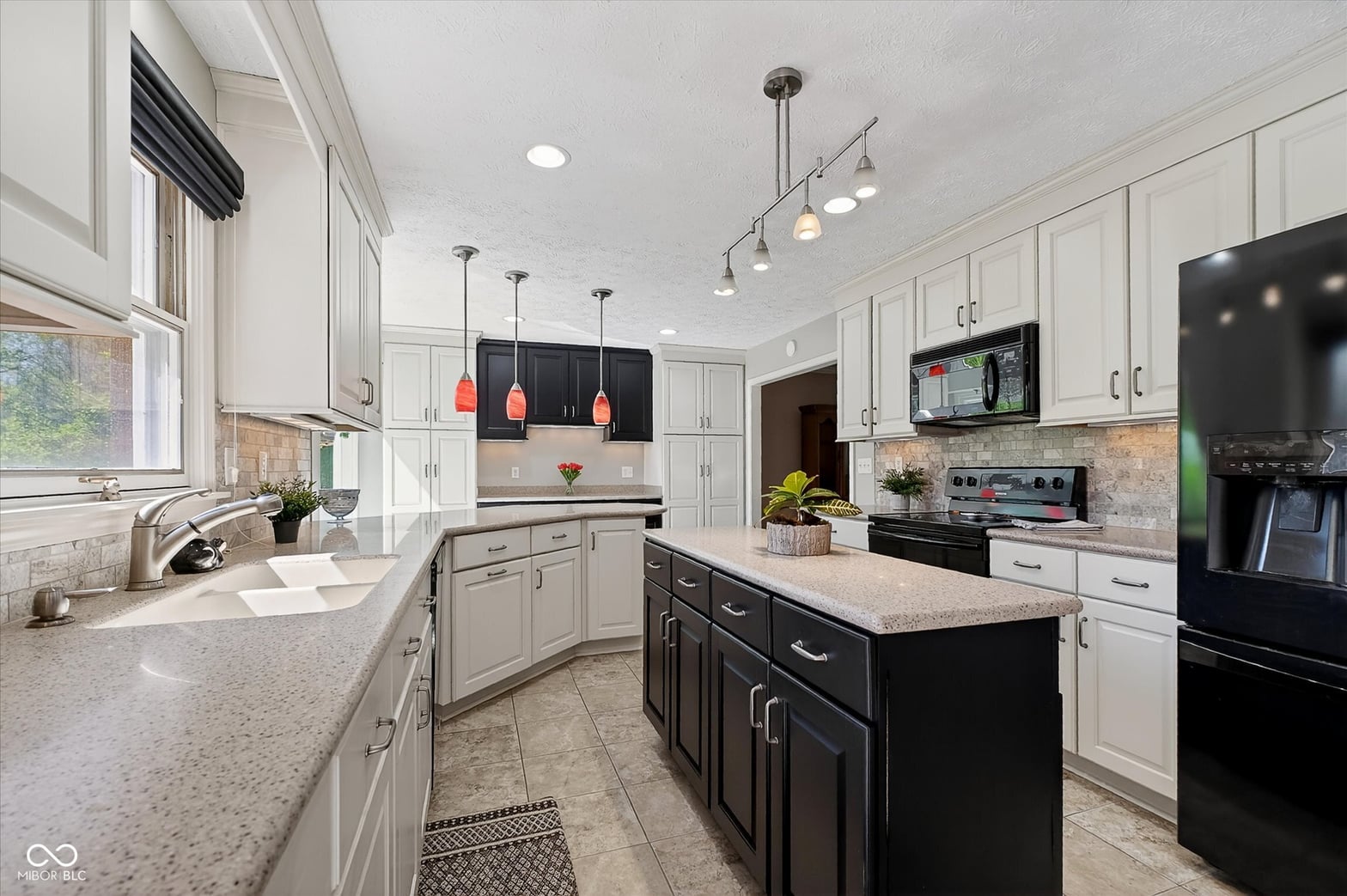 Luxury kitchen with granite counters and modern fixtures.