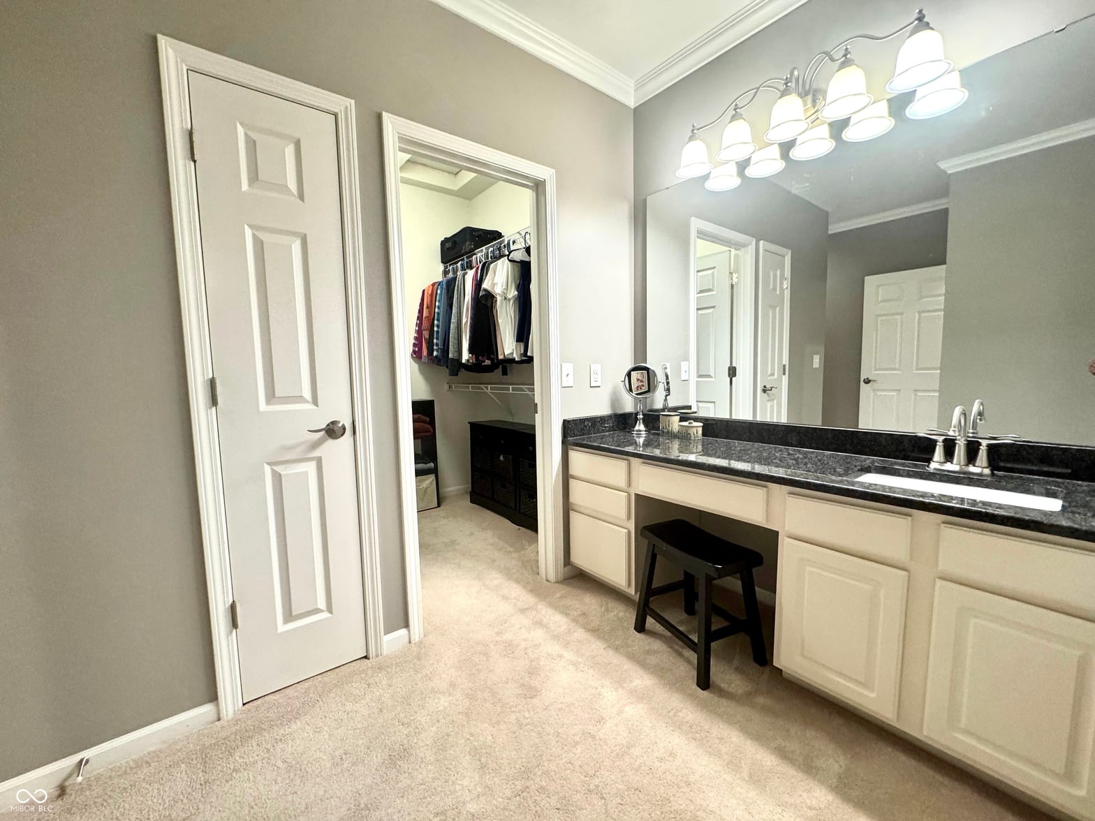 Spacious primary bath with double vanity and walk-in closet.