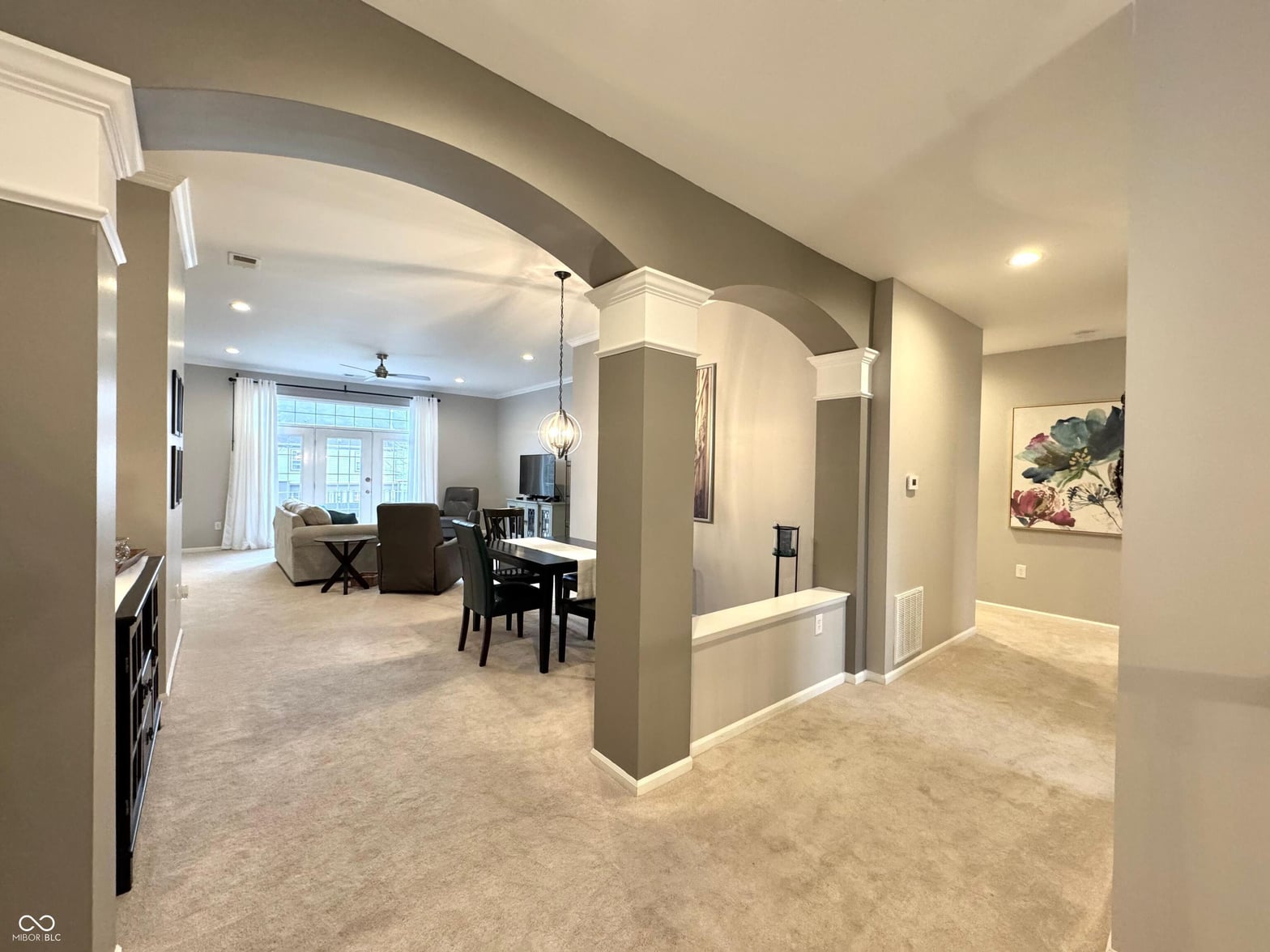 Spacious open-concept family room with elegant architectural details.