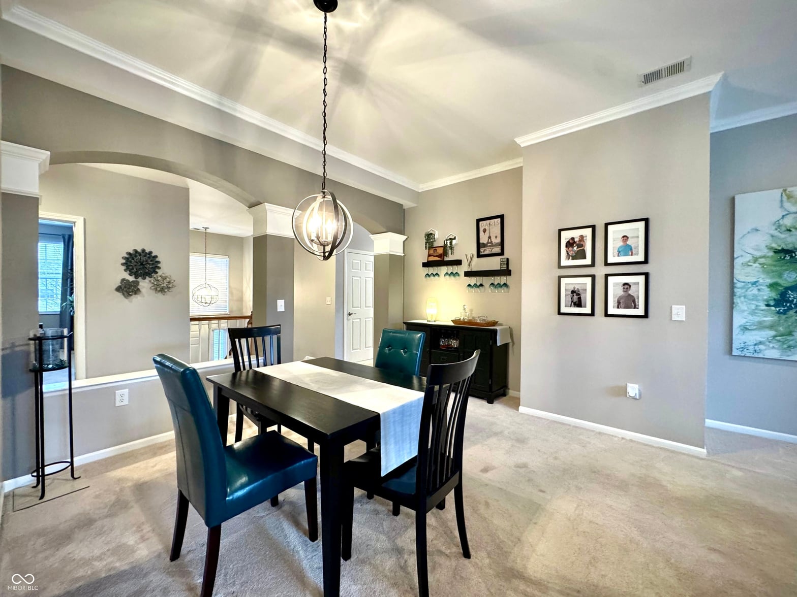 Open dining area with elegant coffered ceilings and pendant lighting.