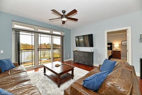 Living room at 20971 Shoreline Court, Noblesville, IN — Spacious living room with scenic water views from balcony.