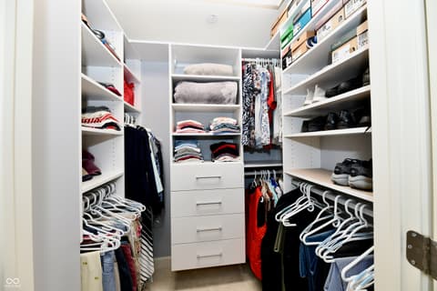 Primary bedroom at 20971 Shoreline Court, Noblesville, IN — Luxurious walk-in closet with custom built-in organization.