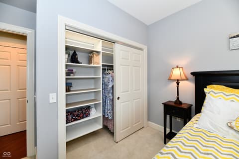 Primary bedroom at 20971 Shoreline Court, Noblesville, IN — Spacious primary bedroom with organized walk-in closet.