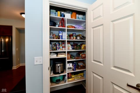 Kitchen at 20971 Shoreline Court, Noblesville, IN — Spacious built-in pantry with extensive organized shelving.
