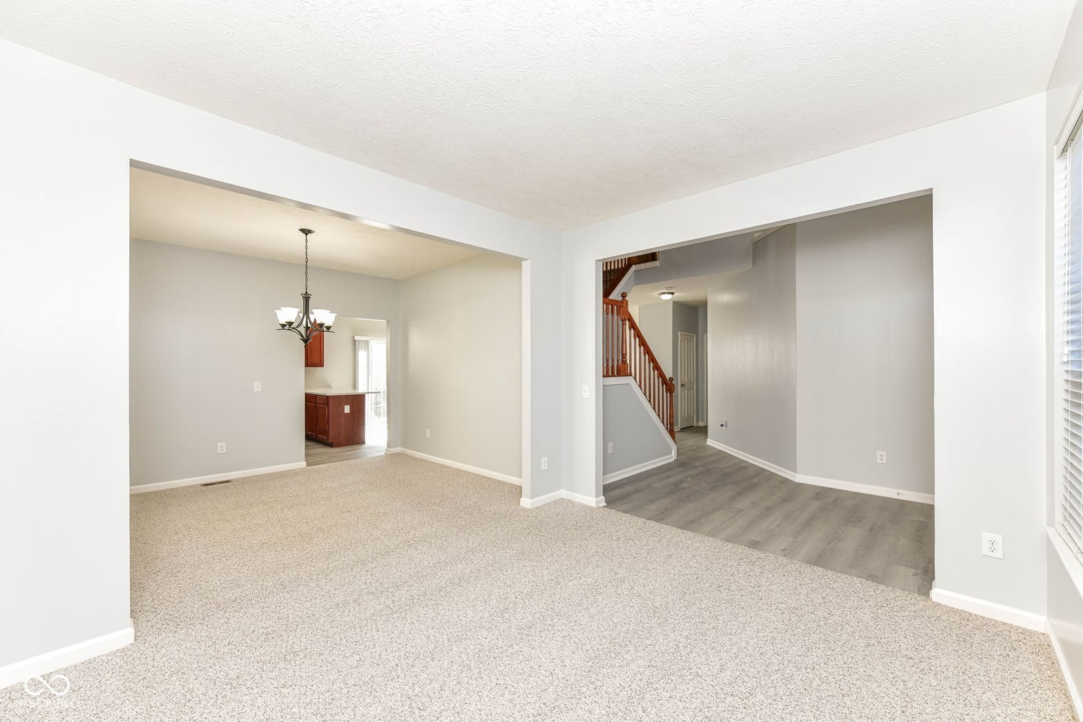 Spacious open-concept family room with neutral finishes.