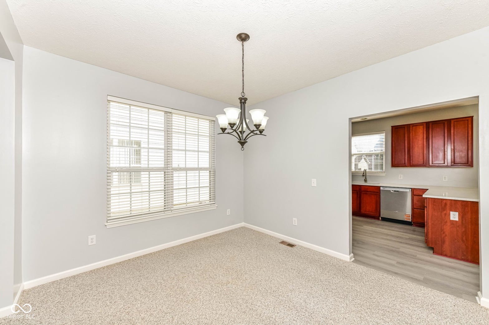 Bright dining space with kitchen visibility and modern fixtures.