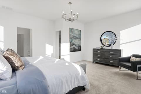 Primary bedroom at 15498 Postman Road, Fishers, IN — Bright modern primary bedroom with ensuite and sitting area.