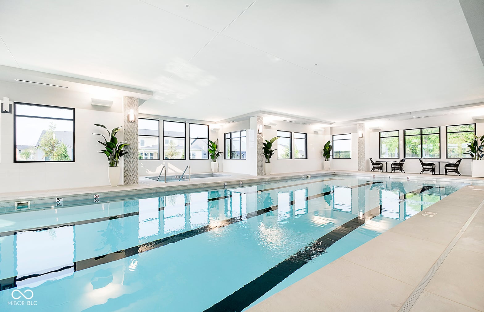 Luxurious indoor lap pool with abundant natural light.