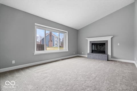 Living room at 792 Grace Drive, Carmel, IN — Bright living room with fireplace and expansive windows.