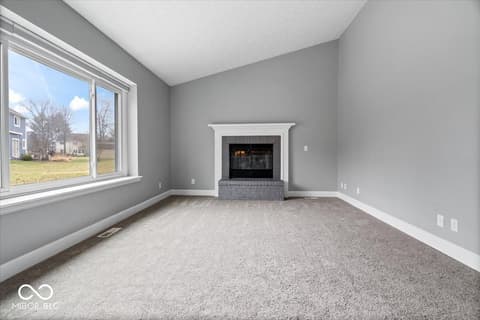 Family room at 792 Grace Drive, Carmel, IN — Bright family room with fireplace and expansive windows.