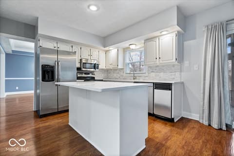 Kitchen at 792 Grace Drive, Carmel, IN — Bright, modern kitchen with stainless appliances and island.
