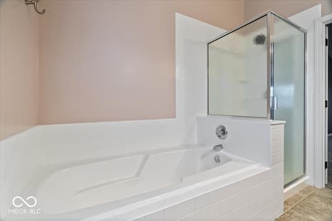 Primary bathroom at 792 Grace Drive, Carmel, IN — Luxurious primary bath with soaking tub and walk-in shower.
