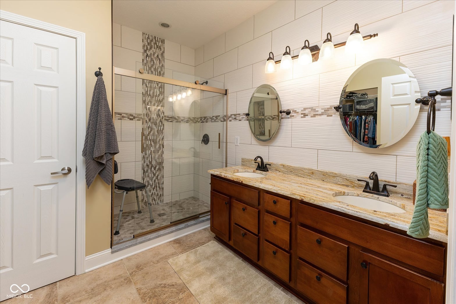 Spacious primary bath with double vanity and walk-in shower.