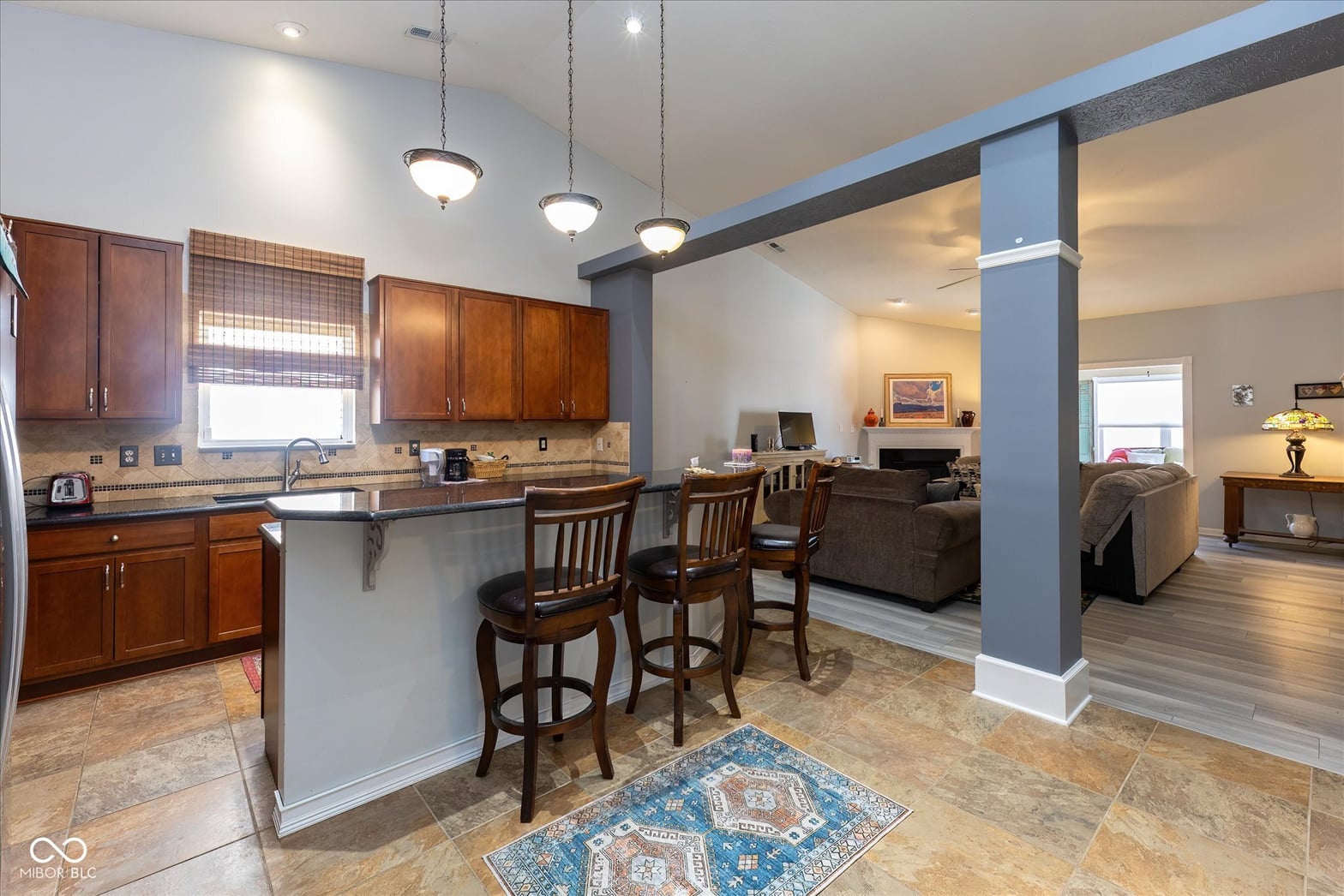 Updated kitchen with island opens to living space.
