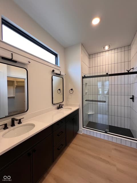 Primary bathroom at 16518 Deerpath Way, Westfield, IN — Stunning primary bath with dual vanity and frameless shower.