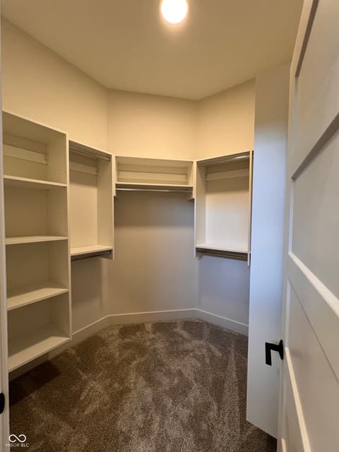 Primary bedroom at 16518 Deerpath Way, Westfield, IN — Spacious primary walk-in closet with built-in organization.