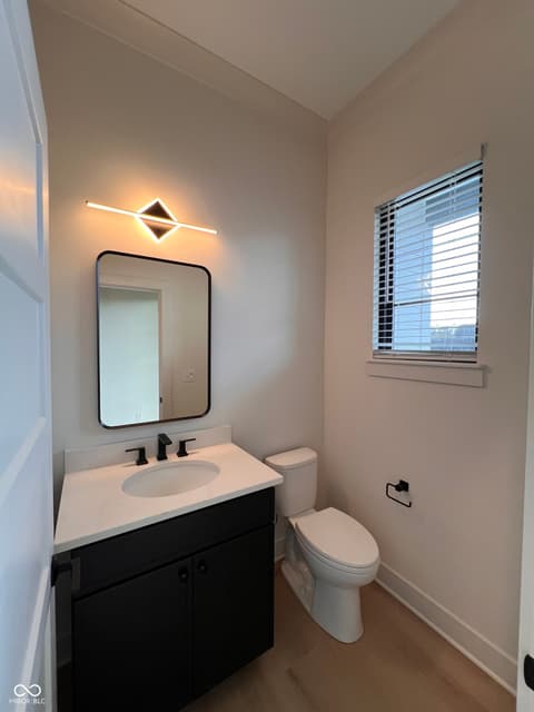 Bathroom at 16518 Deerpath Way, Westfield, IN — Modern bathroom with quartz counters and sleek black vanity.