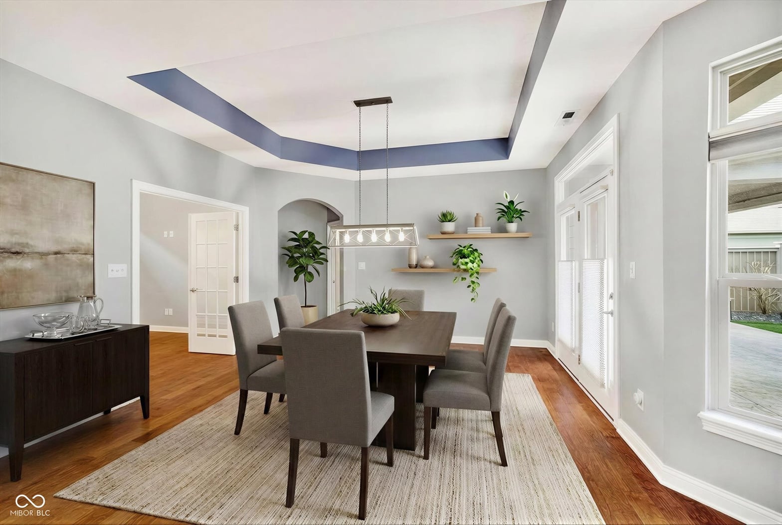Modern dining space with architectural ceiling detail and natural light.