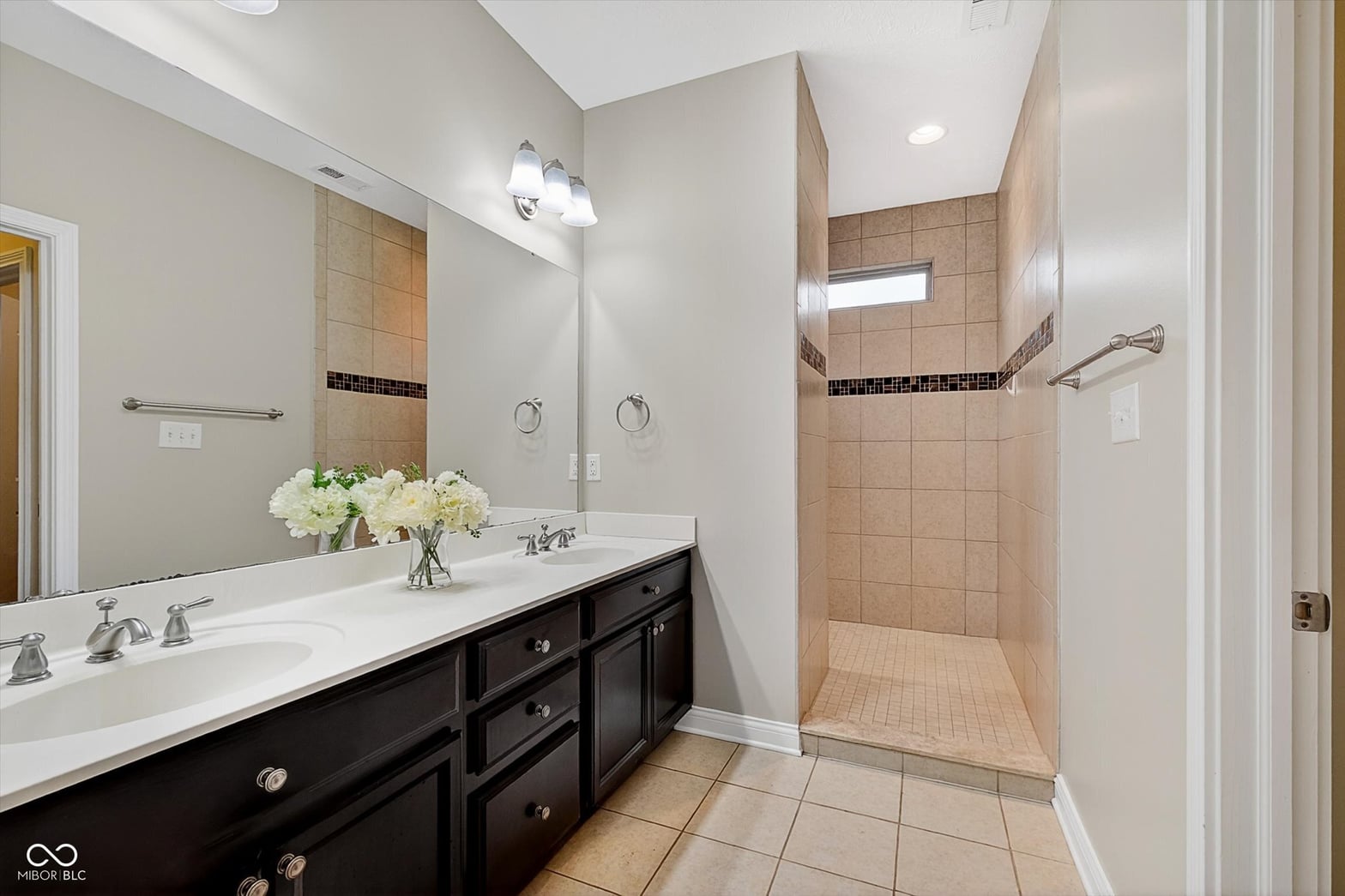 Luxurious primary bath with double vanity and spacious shower.