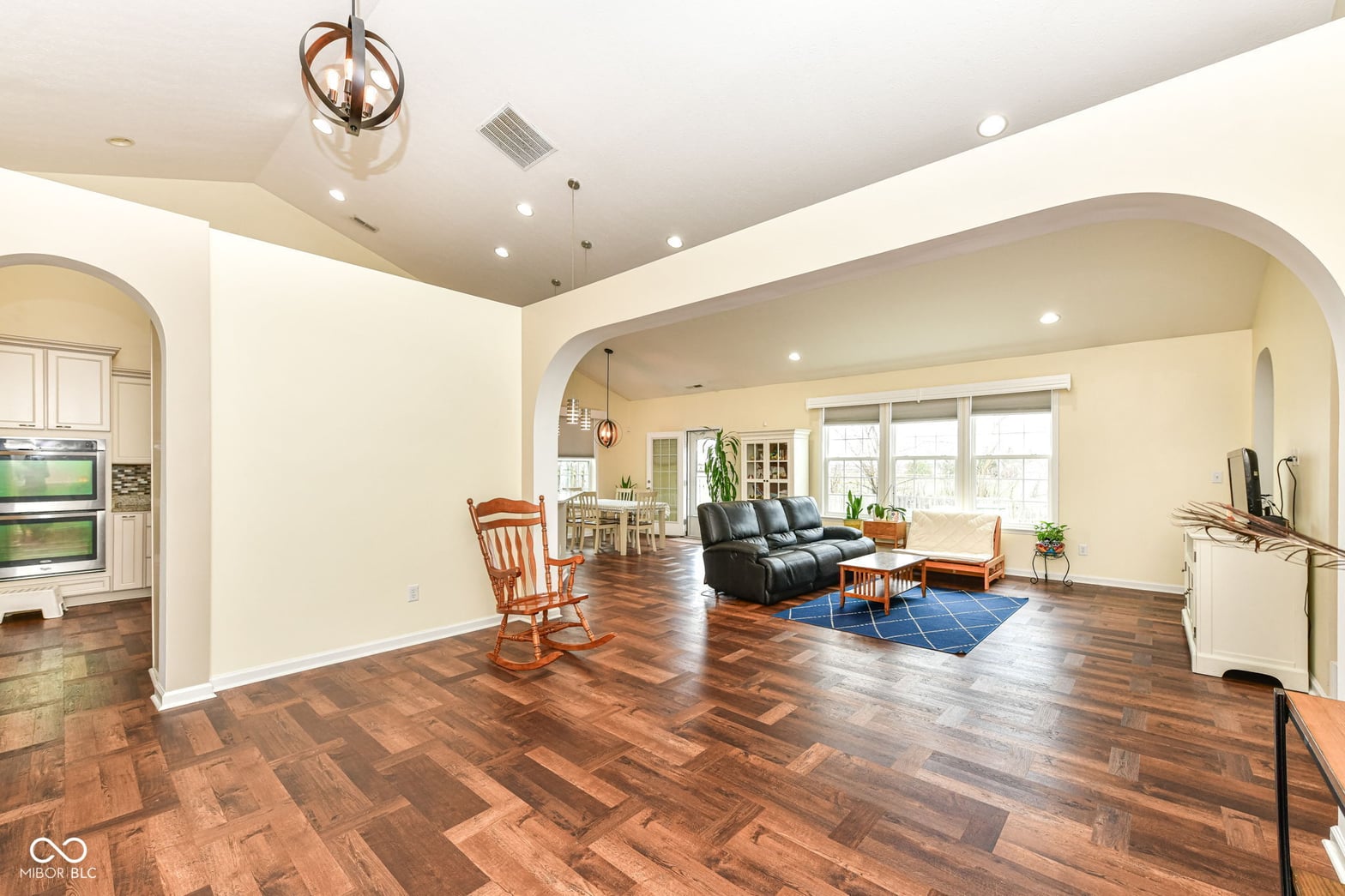 Spacious family room with soaring vaulted ceilings and hardwood floors.