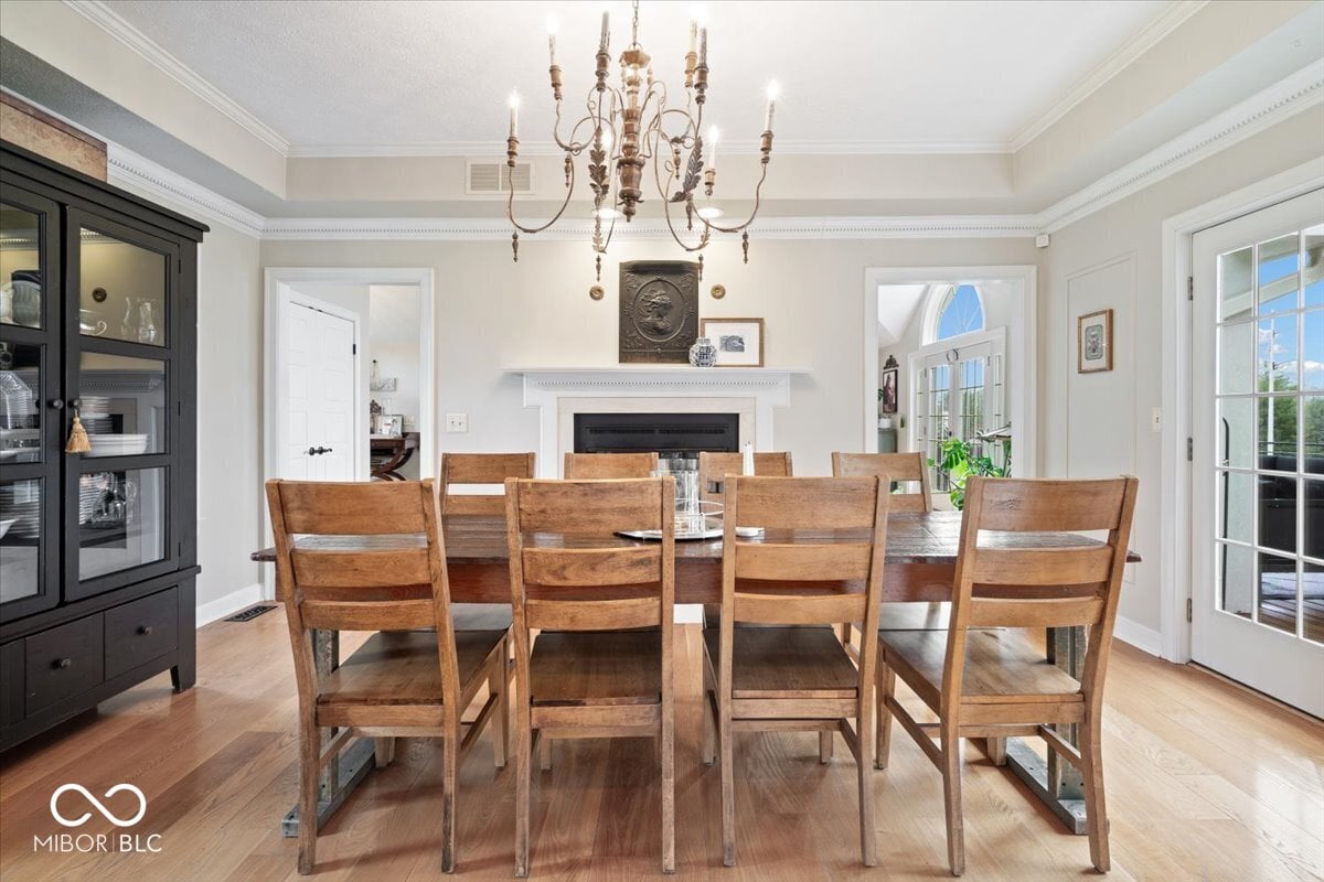 Elegant dining room with fireplace and abundant natural light.