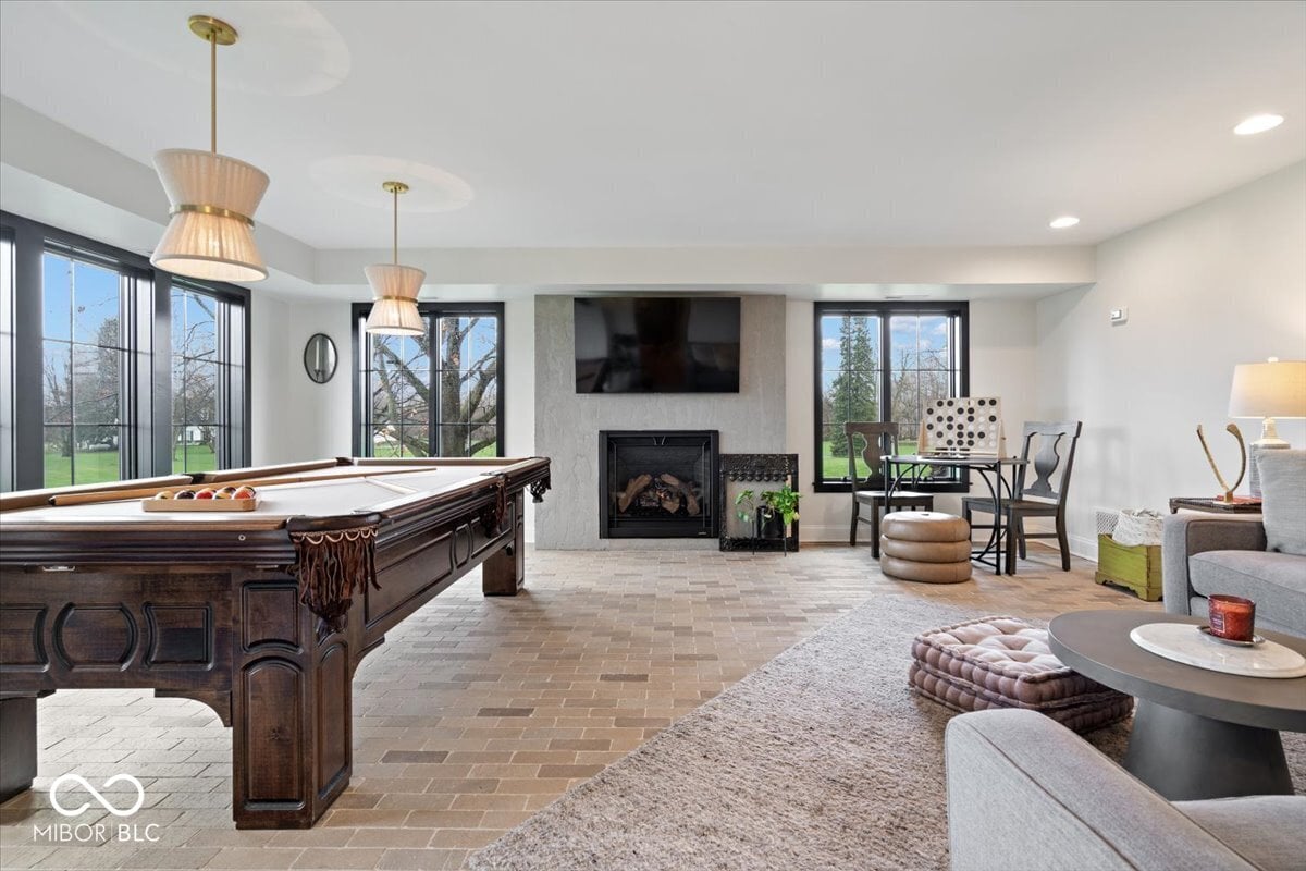Luxury family room with pool table and fireplace