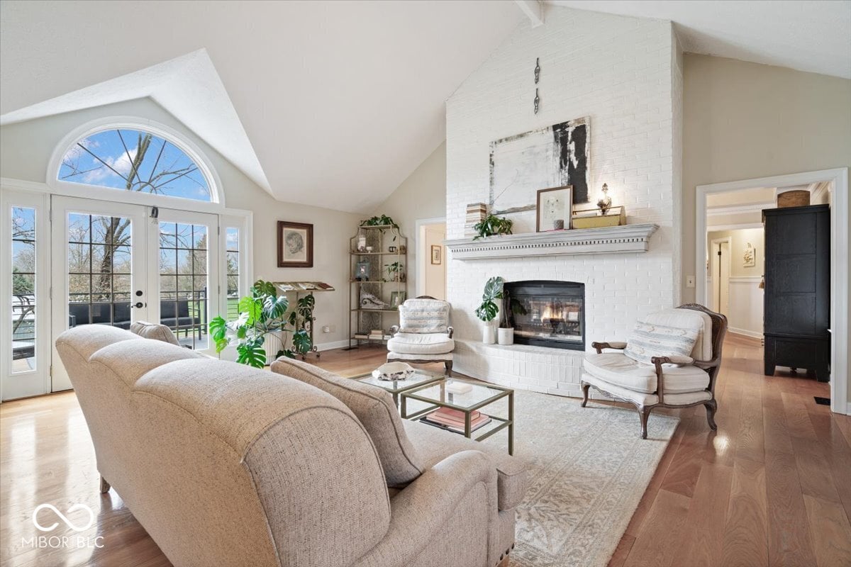 Bright living room with fireplace and abundant natural light.