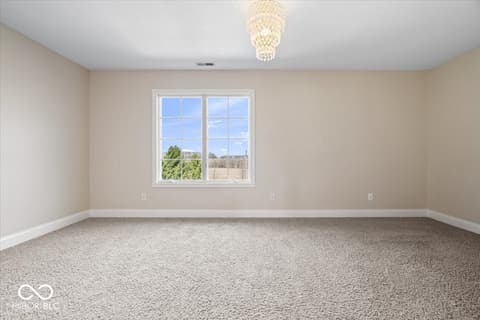 Bedroom at 16540 Shore Oaks Court, Noblesville, IN — Bright bedroom with expansive windows and elegant lighting.