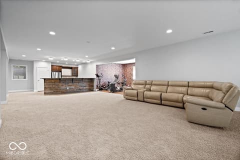 Basement at 16540 Shore Oaks Court, Noblesville, IN — Luxurious basement with wet bar and home theater setup.