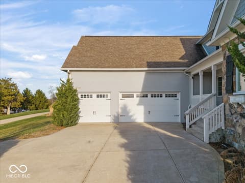 Front exterior at 16540 Shore Oaks Court, Noblesville, IN — Modern home with spacious two-car garage and front porch.
