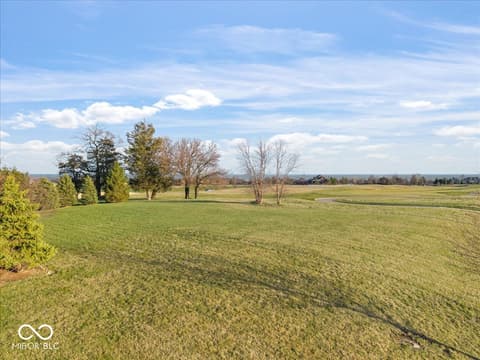 Yard at 16540 Shore Oaks Court, Noblesville, IN — Sprawling grounds with mature landscaping and open views.