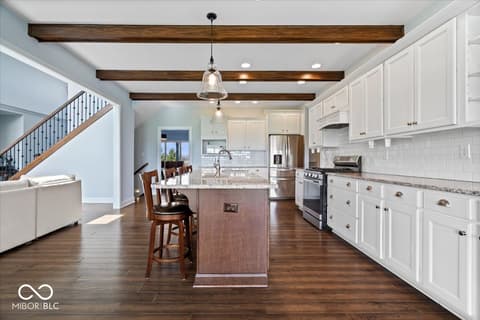 Kitchen at 16540 Shore Oaks Court, Noblesville, IN — Bright kitchen with exposed beams and modern finishes.