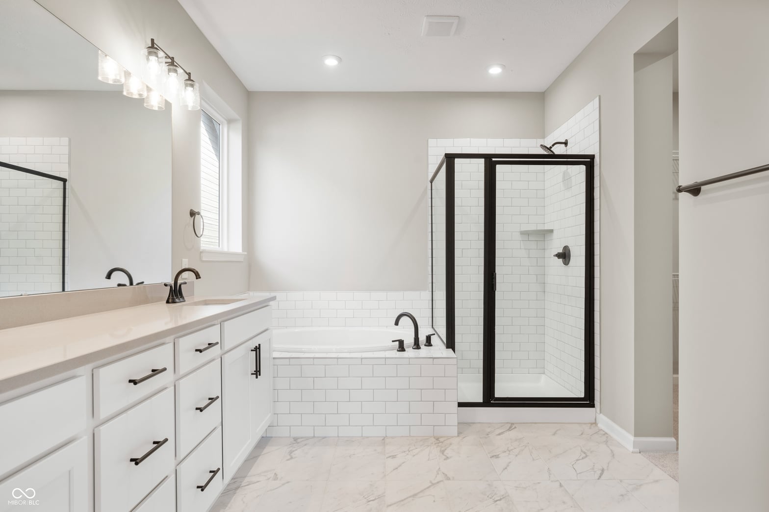 Luxurious spa-like primary bath with soaking tub and shower.