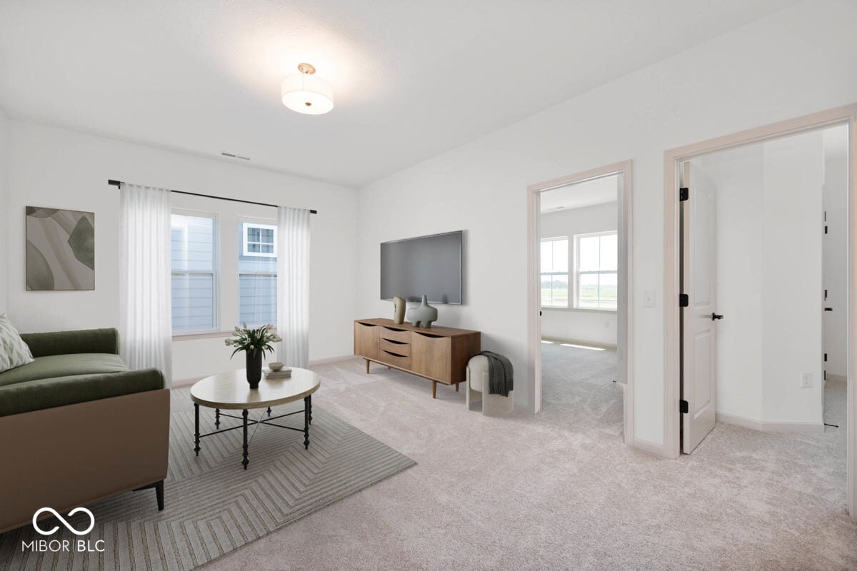 Bright family room with multiple windows and patio access.