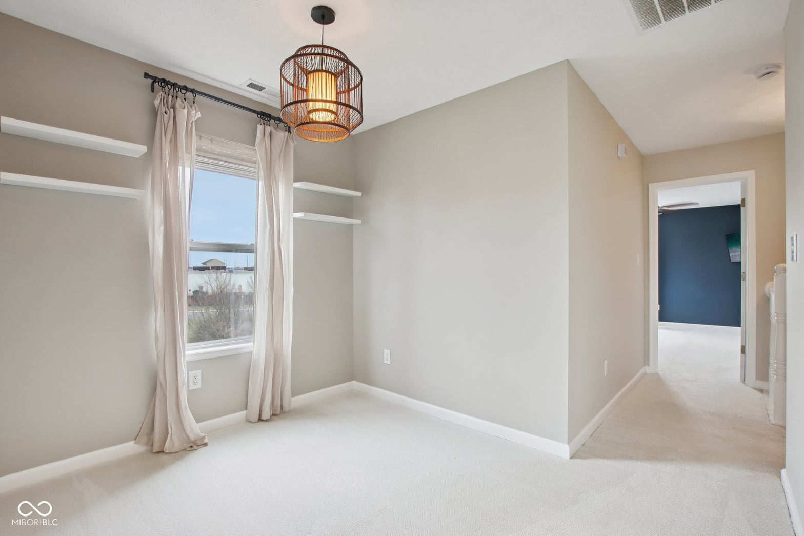 Spacious primary bedroom with water views and walk-in closet.