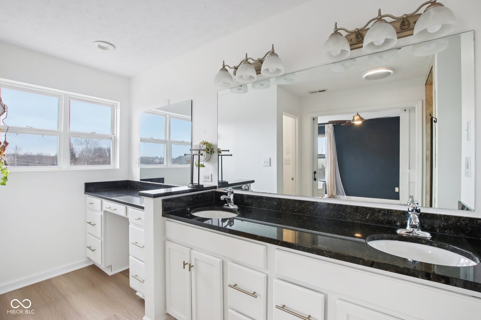 Luxurious primary bath with dual vanity and granite countertops.