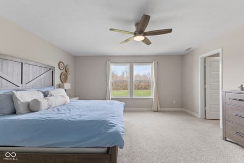 Primary bedroom at 16352 Sedalia Drive, Fishers, IN — Spacious primary bedroom with views of manicured grounds.