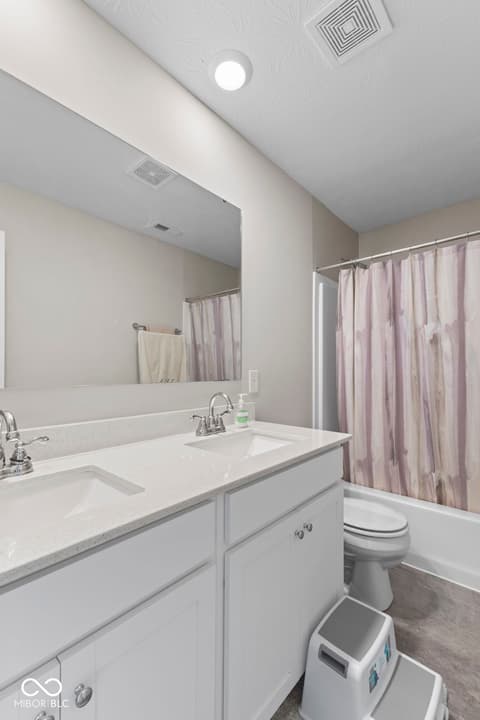 Primary bathroom at 16352 Sedalia Drive, Fishers, IN — Bright primary bath with dual vanity and quartz counters.