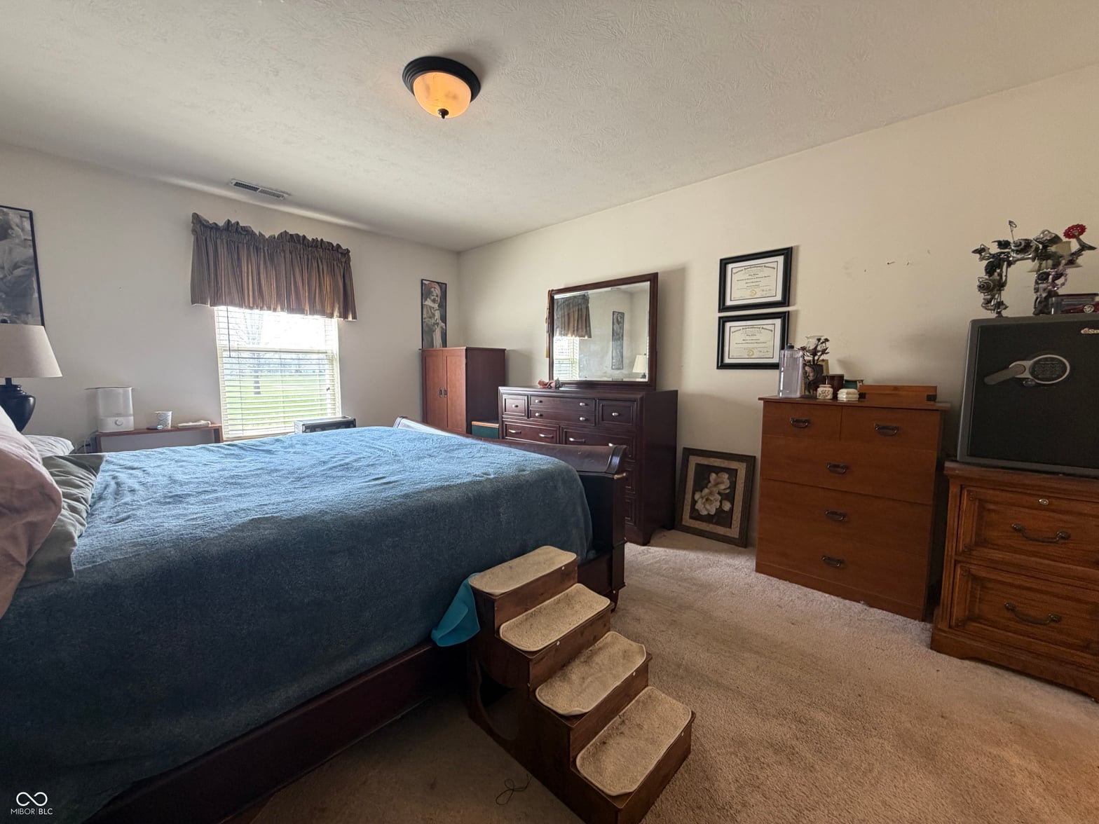 Spacious primary bedroom with abundant natural light and storage.