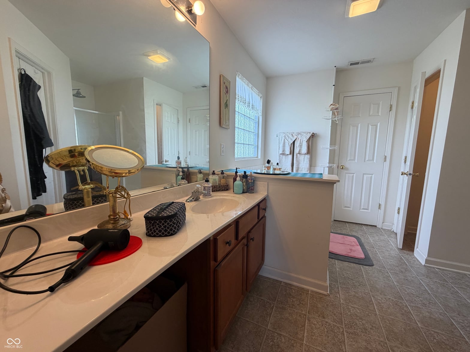 Spacious primary bath with double vanity and elegant finishes.