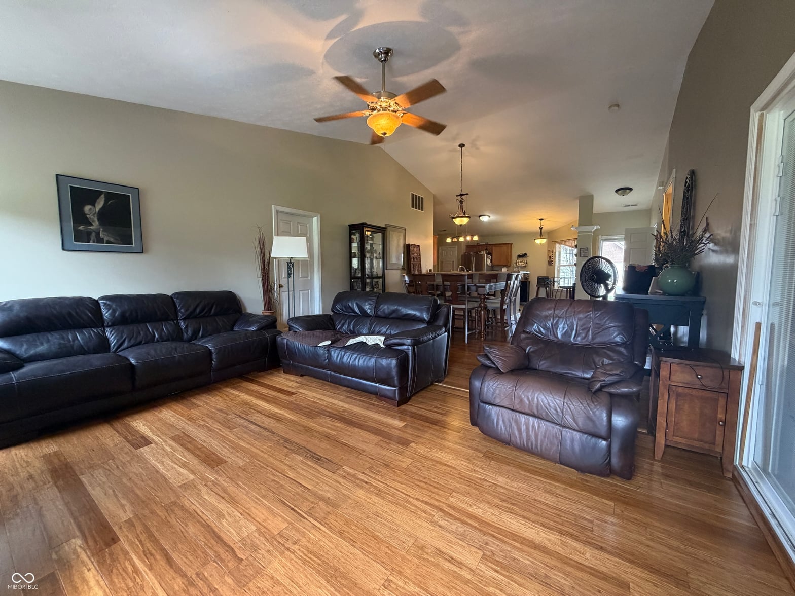 Spacious living room with hardwood floors and vaulted ceilings.