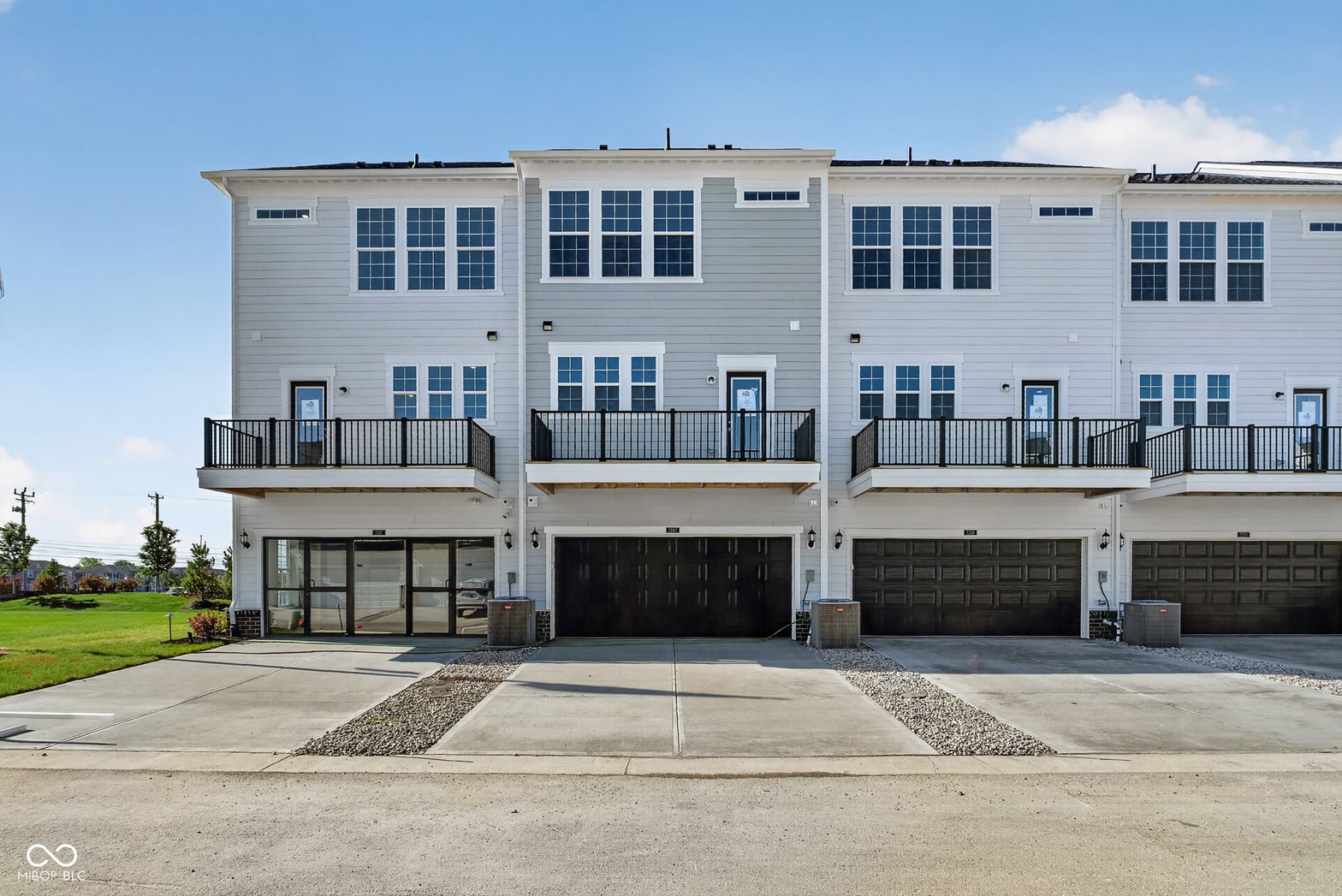 Contemporary townhomes with two-car garage and balconies.
