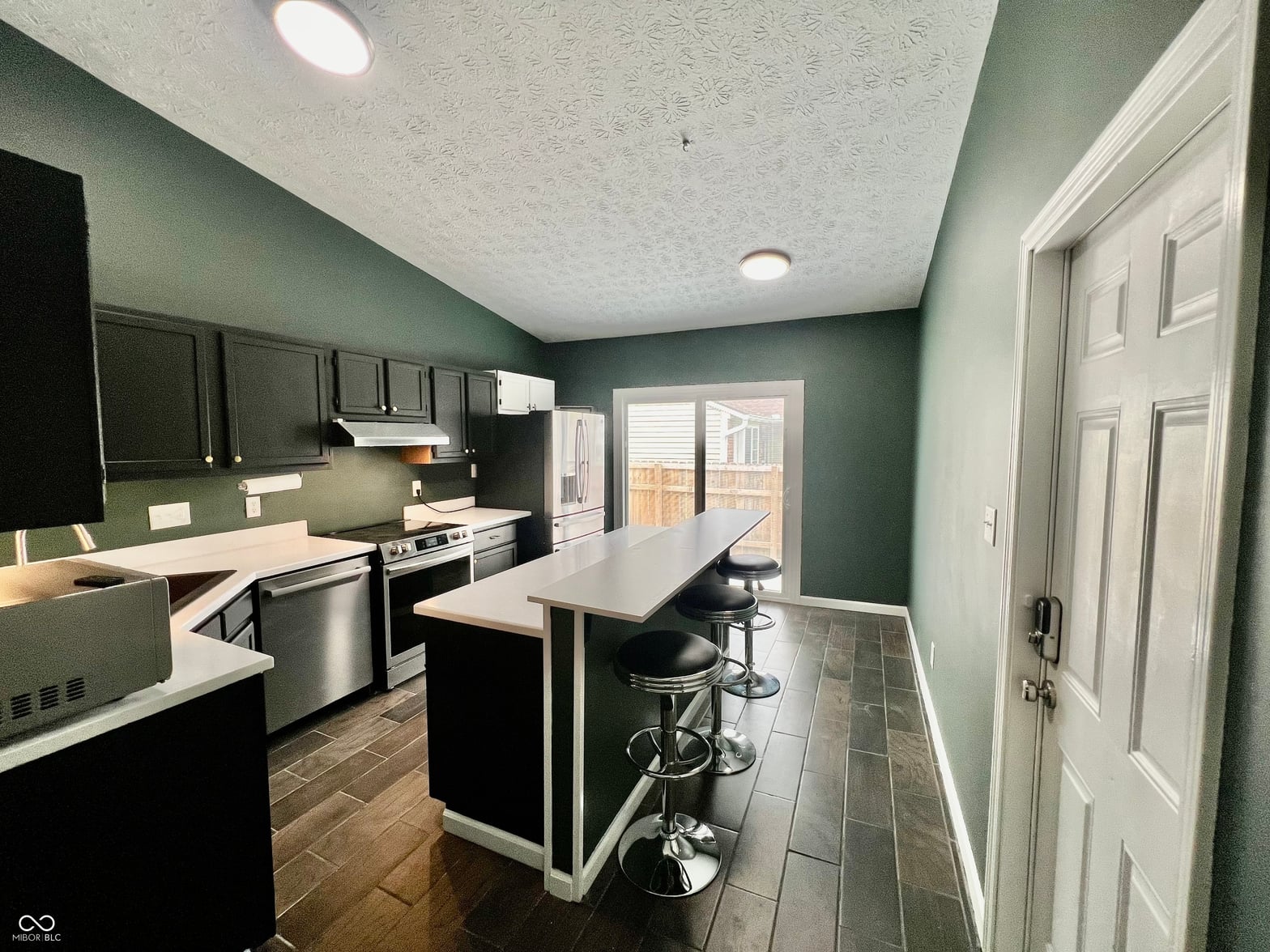Modern kitchen with island and backyard access.