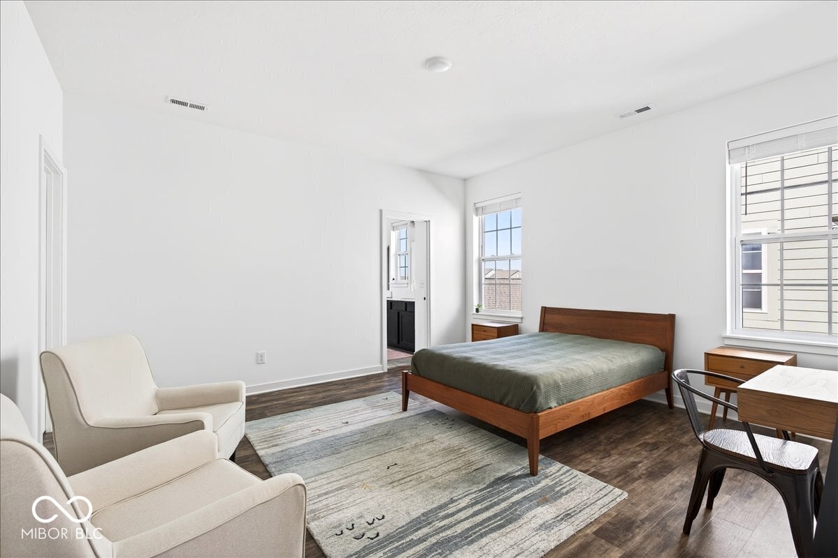 Spacious primary suite with abundant natural light and ensuite access.