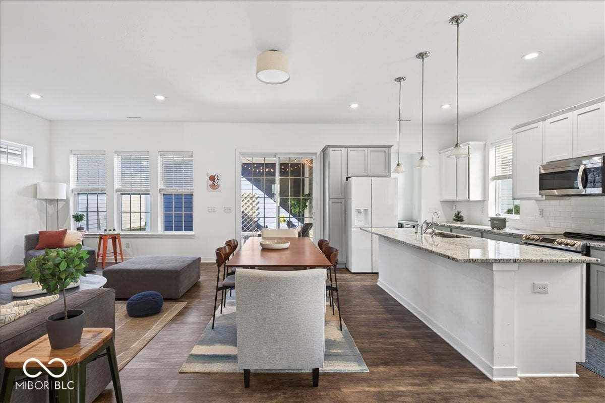 Bright modern kitchen with granite island and open living space.