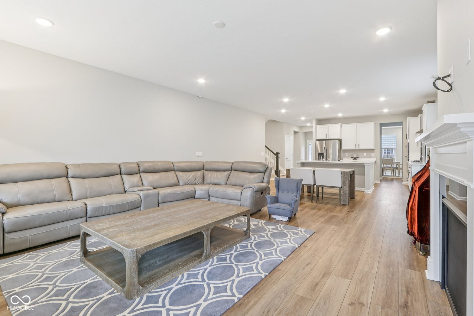 Spacious contemporary family room with hardwood floors and fireplace.