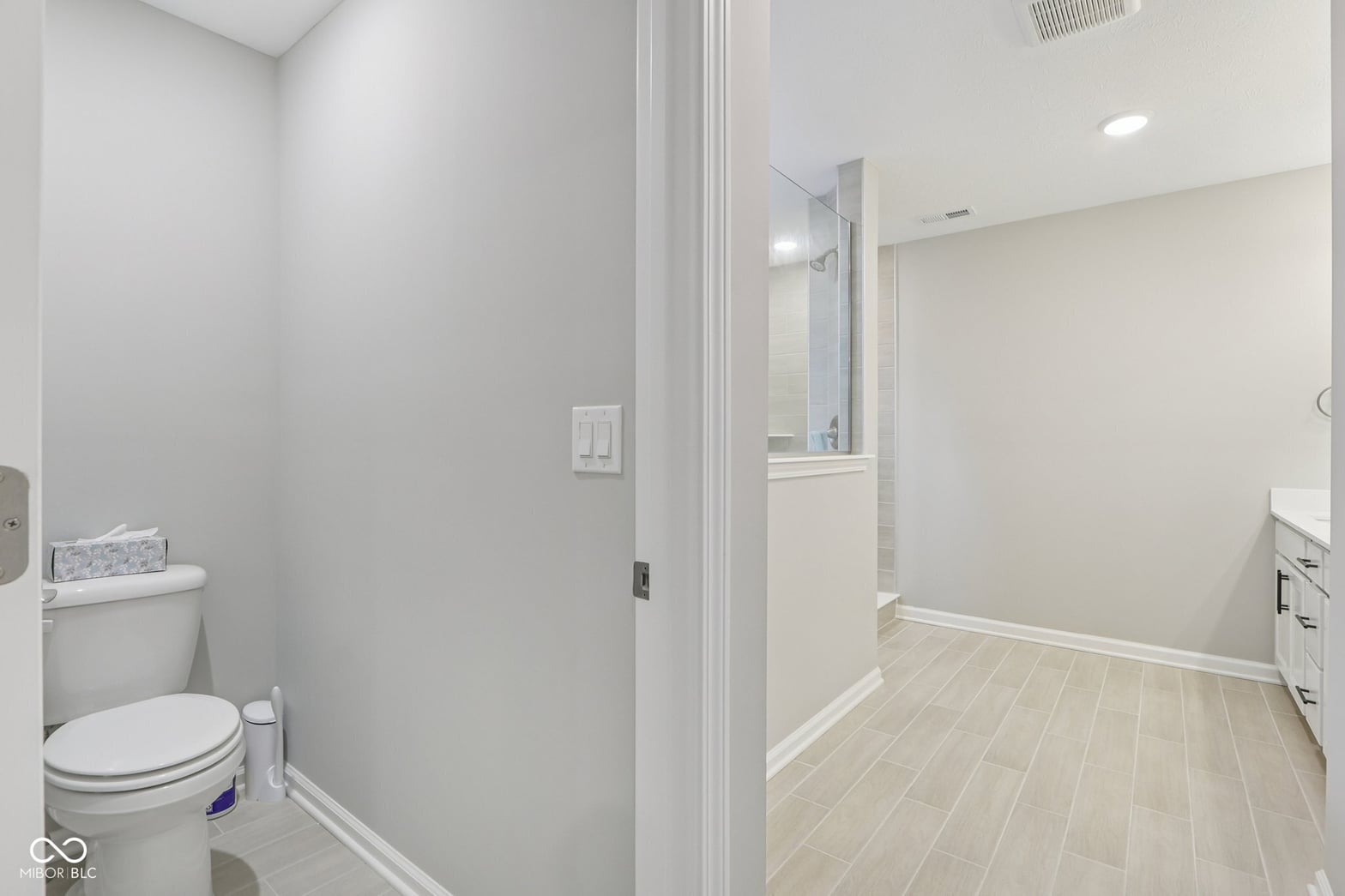 Spacious primary bath with dual vanity and walk-in shower.