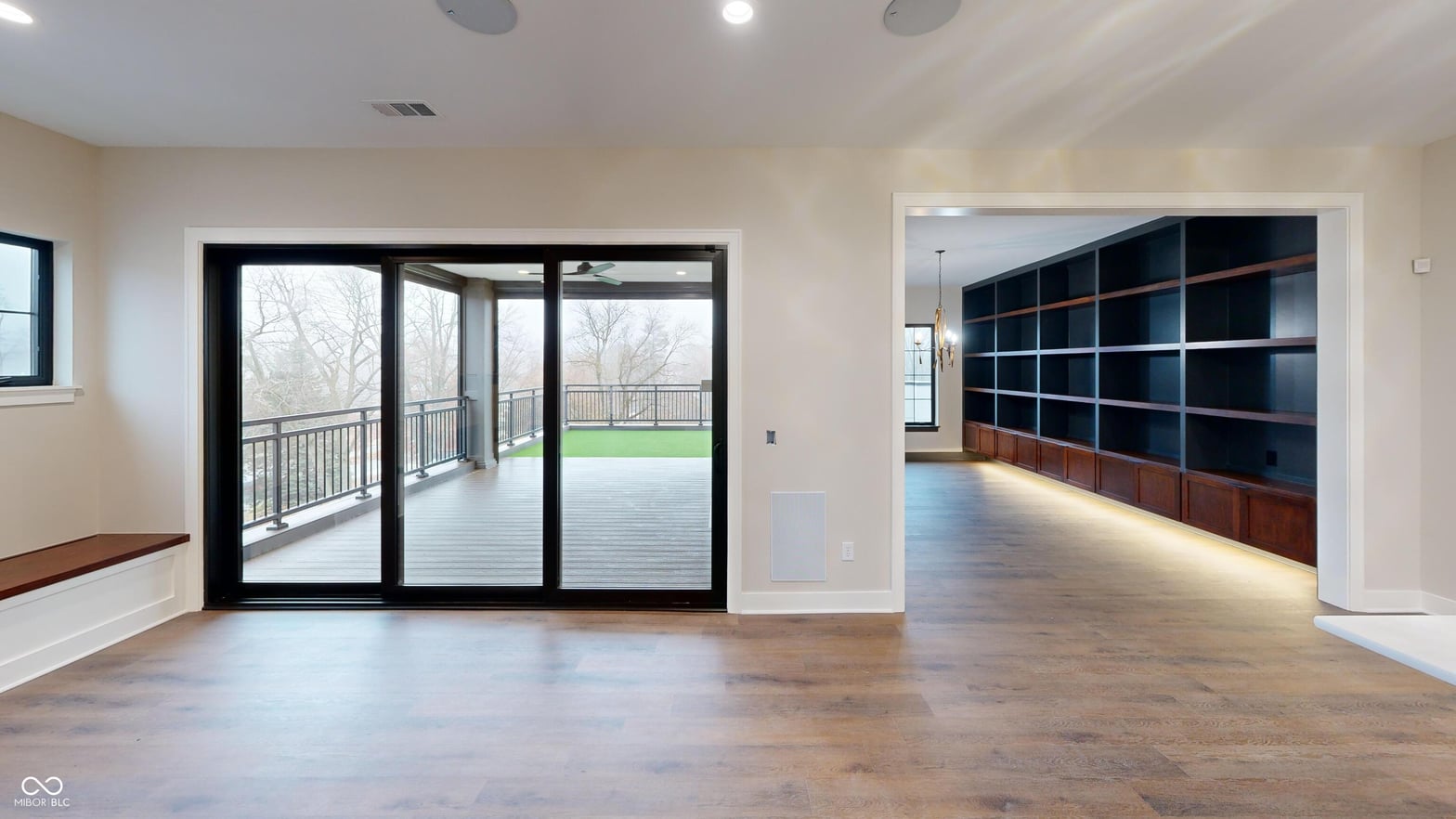 Bright open family room with deck access and custom shelving.