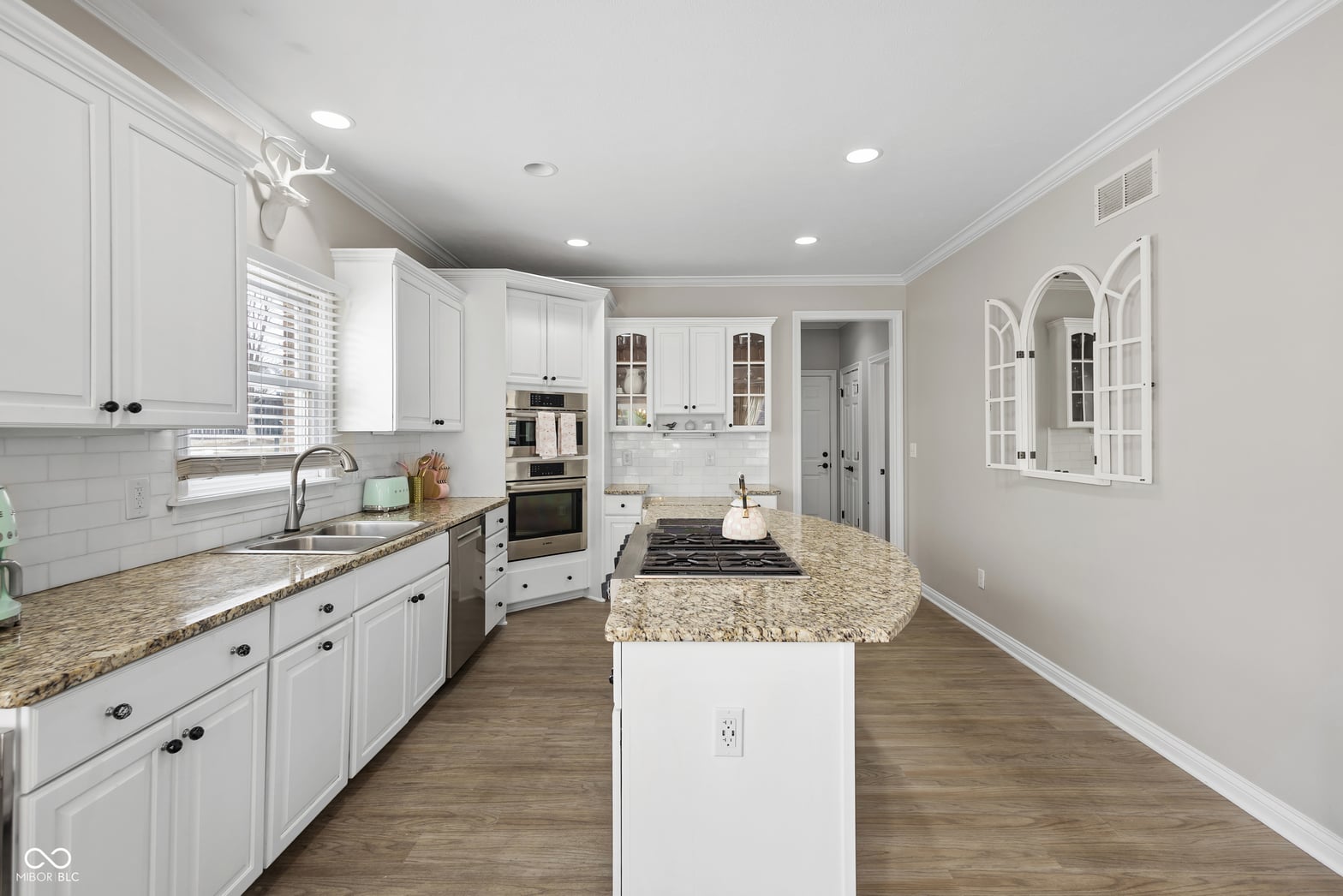 Bright updated kitchen with granite island and stainless appliances.